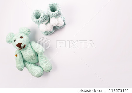 Baby socks and teddy bear on white background. Baby boy birth. Greeting card.Pregnancy announcement. Flatlay, top view Baby socks and teddy bear on white background. Baby boy birth. Greeting card.Pregnancy announcement. Flatlay, top view 112673591