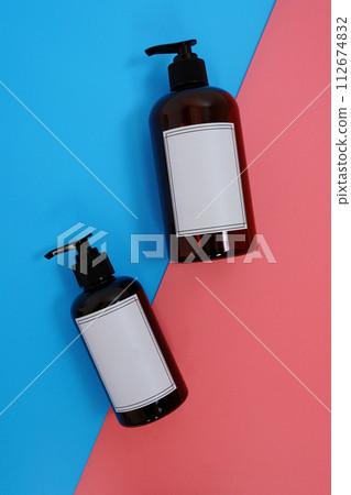 Body care. set of bottles with dispensers on a blue and pink background. Advertising concept 112674832
