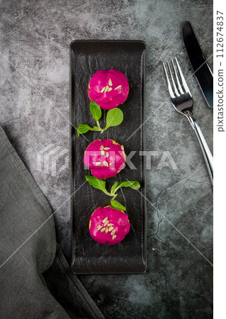 dessert of baked buns with raspberry topping and seed decorations, side view dessert of baked buns with raspberry topping and seed decorations, side view 112674837