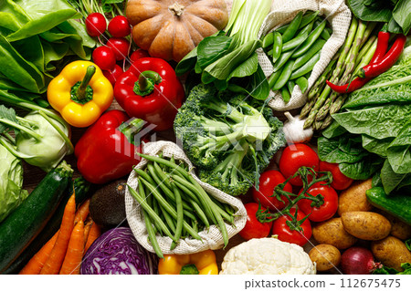 Vegetables background. Various vegetables on kitchen table. Clean eating, healthy food concept, flat lay, top down view 112675475