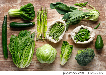 Vegetables background. Various vegetables on kitchen table. Clean eating, healthy food concept, flat lay, top down view 112675477