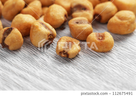 Salted roasted corn snack on a board close up. Whole toasted maize. Salted roasted corn snack on a board close up. Whole toasted maize. 112675491