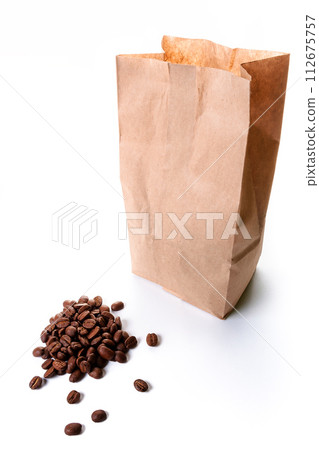 roasted coffee beans spilled in front of a brown disposable package made from craft paper on the white background. recyclable and sustainable mock up concept for eco friendly branding roasted coffee beans spilled in front of a brown disposable package made from craft paper on the white background. recyclable and sustainable mock up concept for eco friendly branding 112675757