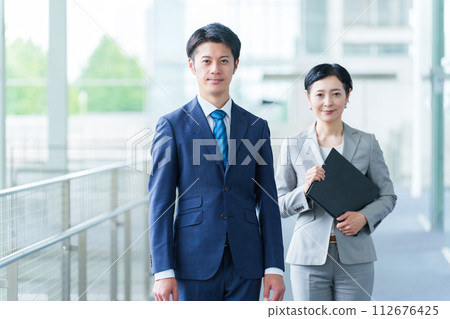 Businessman businesswoman portrait 112676425