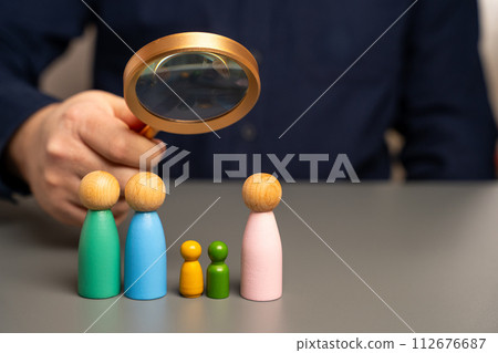 Conceptual image of a same-sex marriage family consisting of two men and children. Choosing LGBT as a lifestyle. Against heterosexual marriage. Wooden figures of people. Conceptual image of a same-sex marriage family consisting of two men and children. Choosing LGBT as a lifestyle. Against heterosexual marriage. Wooden figures of people. 112676687