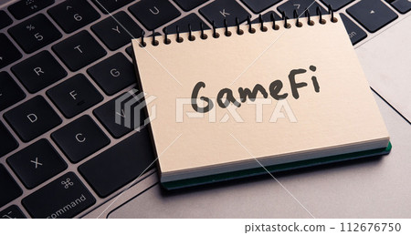 I have a notebook with the word gamefi. As an eye-catching image. 112676750
