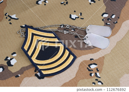 US ARMY Master Sergeant rank patch and dog tags on Desert Battle Dress Uniform US ARMY Master Sergeant rank patch and dog tags on Desert Battle Dress Uniform 112676892