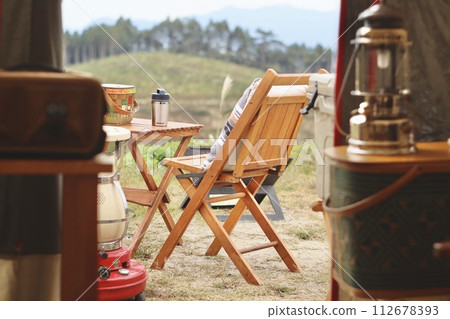 Landscape with table and chairs at campsite 112678393