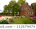 Red brick building and tulip garden 112679474