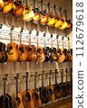 Guitars lined up at a music store 112679618