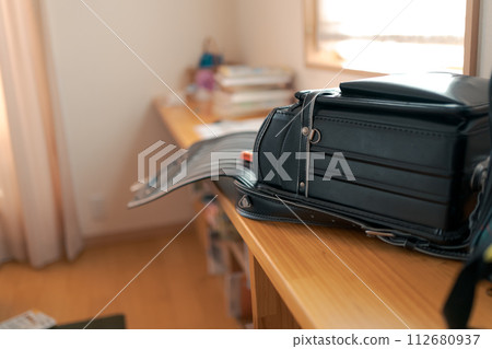 black school bag placed in the living room 112680937