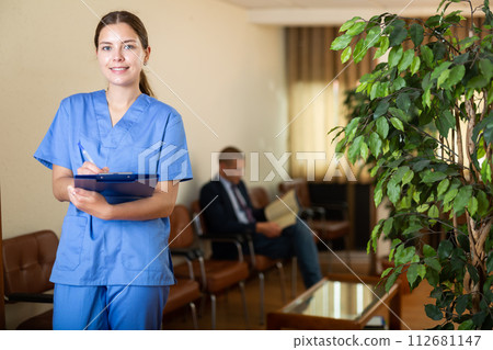 Portrait of female doctor wearing uniform with folder 112681147