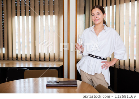 Portrait of a successful young businesswoman standing in a conference room 112681169