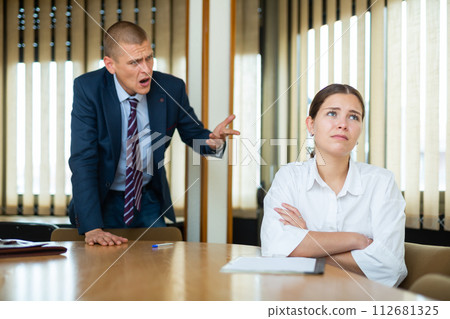Unhappy man chief screaming to female manager 112681325