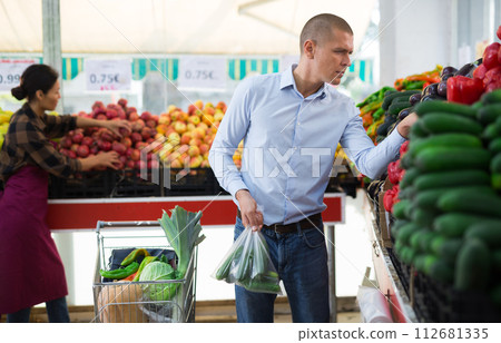 European man shopping in greengrocery European man shopping in greengrocery 112681335