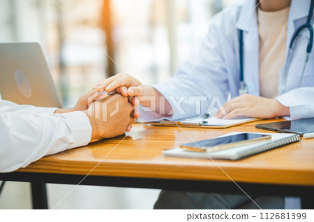 doctor hand holding the patient's hand. To encourage and comfort the patient so that the patient is not sad and worried. 112681399