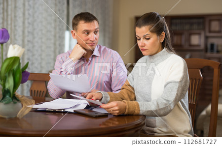 Couple filling out financial documents Couple filling out financial documents 112681727