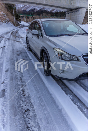 Four-wheel drive vehicles and all-season tires allow you to drive safely on snowy roads 112682707