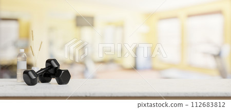 A presentation space on a white table features dumbbells and a water bottle in a modern fitness. A presentation space on a white table features dumbbells and a water bottle in a modern fitness. 112683812