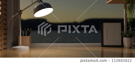The presentation space on a wooden desk in a modern home office at night. The presentation space on a wooden desk in a modern home office at night. 112683822