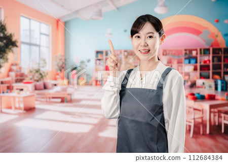 Nursery teacher working with a smile 112684384
