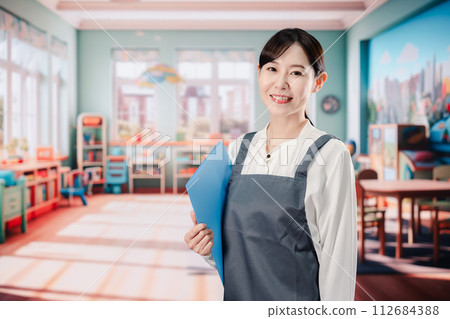 Nursery teacher working with a smile 112684388