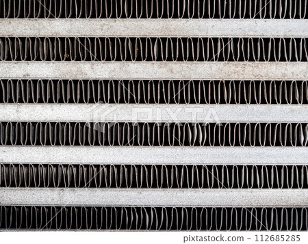 The metal grill of a car radiator is old and has scale marks The metal grill of a car radiator is old and has scale marks 112685285