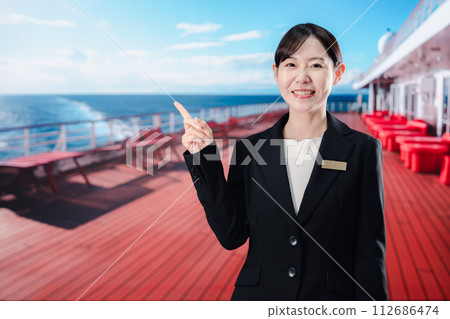 A female sailor greets passengers on a cruise ship 112686474