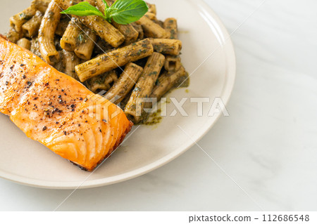 pesto quadrotto penne pasta with grilled salmon 112686548
