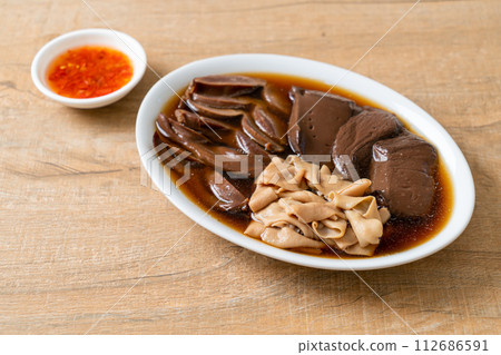 stewed duck offal in brown soup stewed duck offal in brown soup 112686591