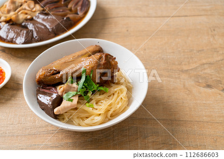 dried noodles with braised duck in white bowl dried noodles with braised duck in white bowl 112686603