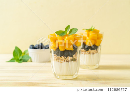homemade mango and blueberry with yogurt and granola homemade mango and blueberry with yogurt and granola 112686757