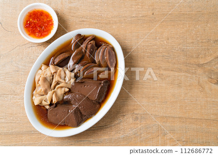 stewed duck offal in brown soup 112686772