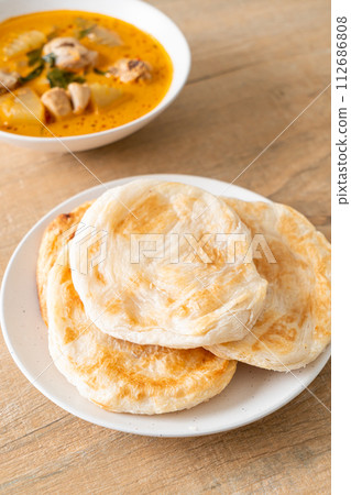 Chicken curry soup with roti Chicken curry soup with roti 112686808