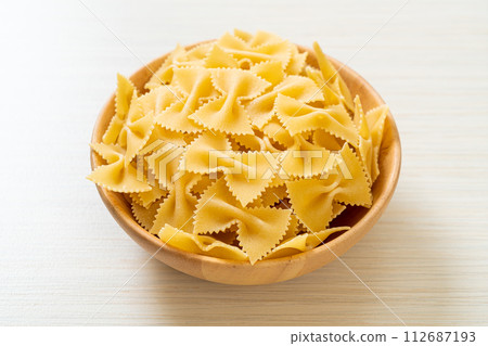 Dry uncooked farfalle pasta in bowl Dry uncooked farfalle pasta in bowl 112687193