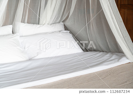 white comfortable pillows on bed 112687234