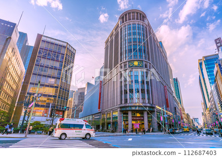 Tokyo cityscape in Japan An ambulance runs through the Nihonbashi-Kitazume intersection with its siren blaring and checking for safety. Tokyo cityscape in Japan An ambulance runs through the Nihonbashi-Kitazume intersection with its siren blaring and checking for safety. 112687403