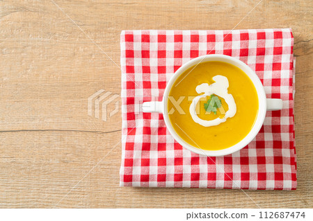 pumpkin soup in white bowl pumpkin soup in white bowl 112687474