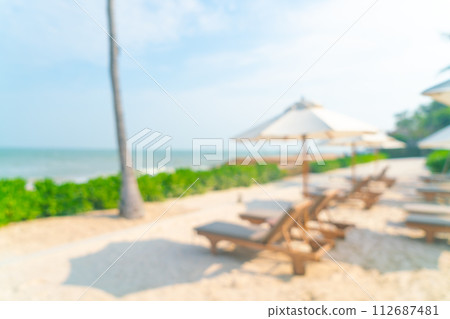 abstract blur umbrella with beach chair for background abstract blur umbrella with beach chair for background 112687481