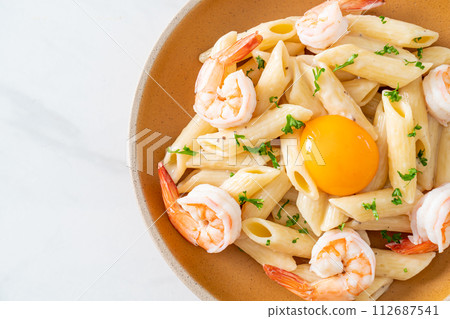 penne pasta white cream sauce with shrimps and egg 112687541