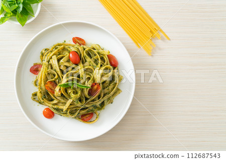 fettuccine spaghetti pasta with pesto sauce and tomatoes fettuccine spaghetti pasta with pesto sauce and tomatoes 112687543