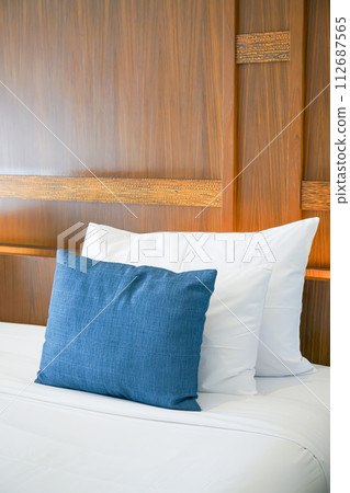 comfortable pillows and white pillows on bed 112687565