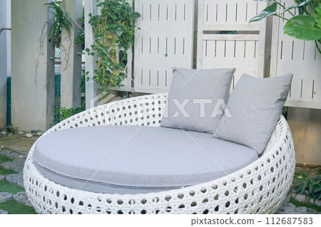 comfortable pillows on wicker chair 112687583