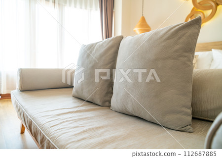 comfortable pillows on end of bed sofa 112687885