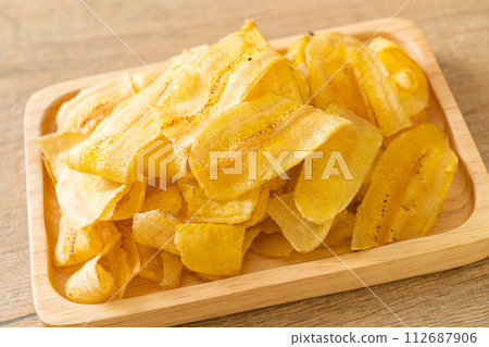Banana Chips - fried or baked sliced banana 112687906