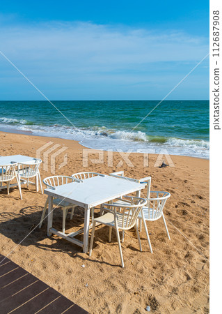 dinning table and chair on beach with sea background 112687908