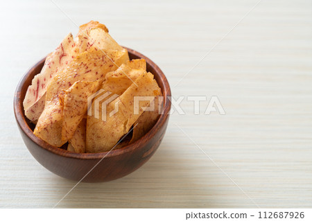 Taro Chips - fried or baked sliced taro 112687926
