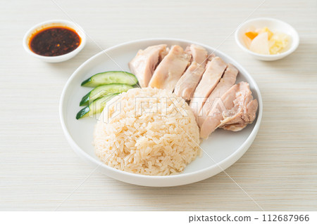 Hainanese chicken rice or rice steamed with chicken soup Hainanese chicken rice or rice steamed with chicken soup 112687966