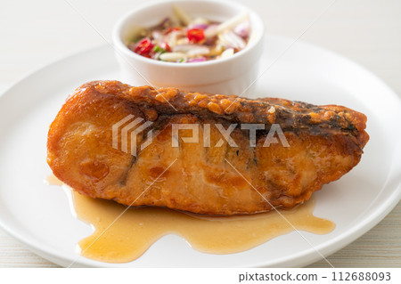 fried snapper fish with fish sauce and spicy salad fried snapper fish with fish sauce and spicy salad 112688093
