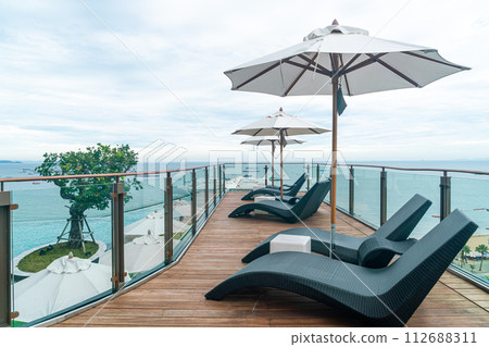 bed pool with umbrella around swimming pool bed pool with umbrella around swimming pool 112688311